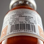 Close-up of a bottle label with text and a barcode on a gray background. Compliance-Ready Food Labels: Nutrition & Ingredients