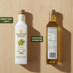 Two bottles of Karoo Gold olive oil on a wooden surface with labels highlighted. Compliance-Ready Food Labels: Nutrition & Ingredients