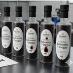 Five bottles of MZANISI Gourmet Balsamic Vinegar on a reflective surface with a blurred background. Compliance-Ready Food Labels: Nutrition & Ingredients