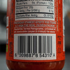 Close-up of a red bottle label with text and a barcode. Compliance-Ready Food Labels: Nutrition & Ingredients