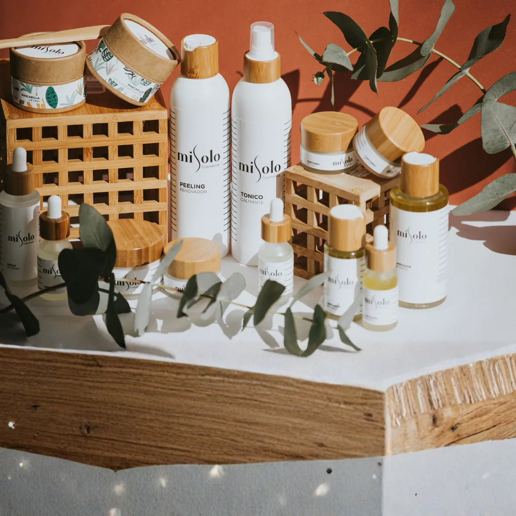 Skincare products with 'mi solo' branding on a wooden surface with green leaves. Labels and Print Solutions for Pro Small Batch Labels