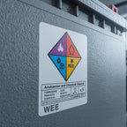 Label on a large metal container indicating chemical hazard with various symbols. SANS-Compliant Battery Labels: Self-Adhesive from 1XA4🔋⚡