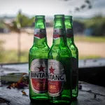 Three Bintang beer bottles on a white background
