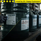 Large black oil drums with labels on a warehouse shelf, loved by 1K+ happy customers text at the top. Lubricant Oil Labelling Near Me | SANS 10234 Compliant