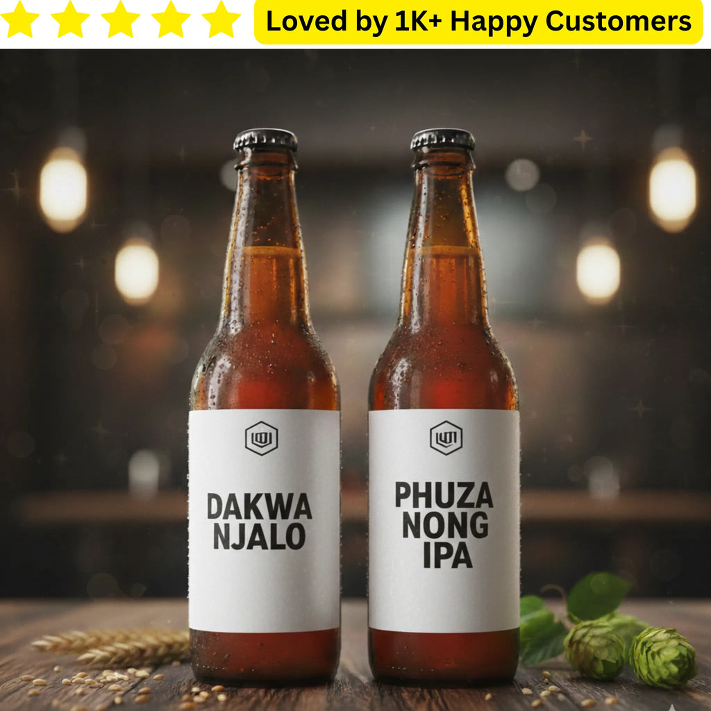 Two bottles of beer with labels 'Dakwa Njalo' and 'Phuza Nong IPA' on a wooden surface with a blurred background.