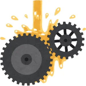 Two gears with splashes of yellow liquid on a white background